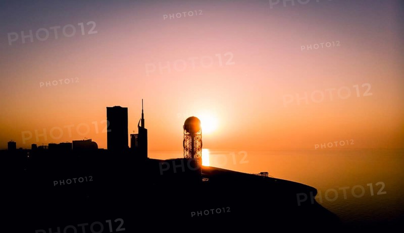 Panoramic silhouette of Batumi city skyscrapers from distance with blue sea water in the background. Georgiatravel iliustration concept. Batumi.Georgia