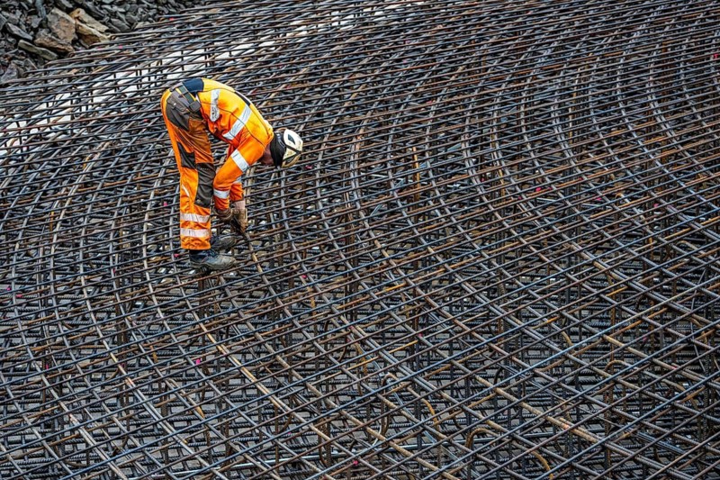 Assembly of reinforcing steel for the reinforced concrete foundation of a wind turbine, a mesh of rebar and reinforcing steel mesh, connecting the steel elements with binding wire, twisting with tongs, over 100 tons of reinforcing steel were used, the wind turbine will have a hub height of 160 meters, part of a new wind farm in Sauerland, near Balve, North Rhine-Westphalia, Germany