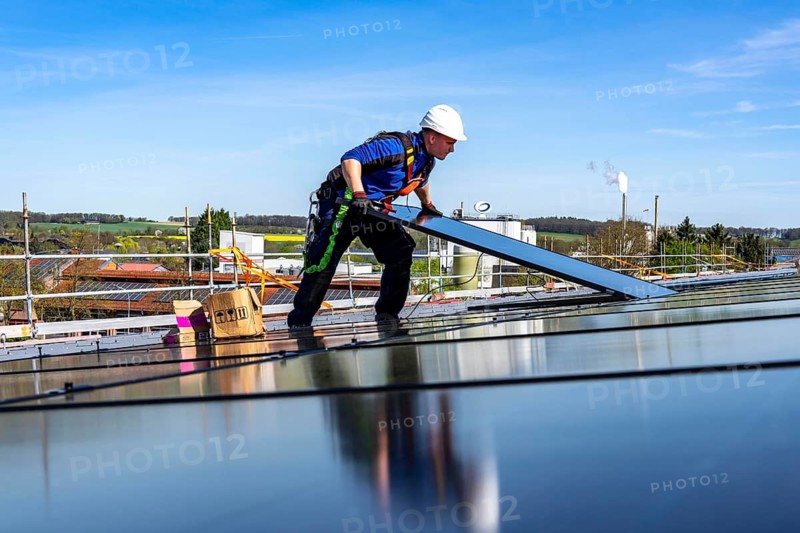 Installation of solar modules on the roof of a commercial enterprise, over 400 photovoltaic modules are installed on the roof, North Rhine-Westphalia, Germany
