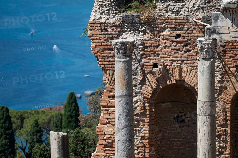 View of ancient theatre pillars and the Mediterranean Sea, Taormina, Sicily, Italy