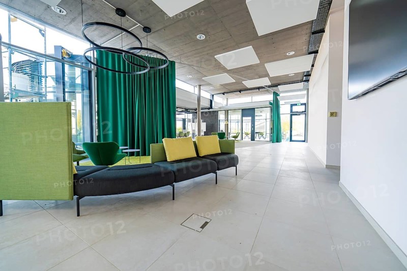 Modern lobby with open room design and green curtains