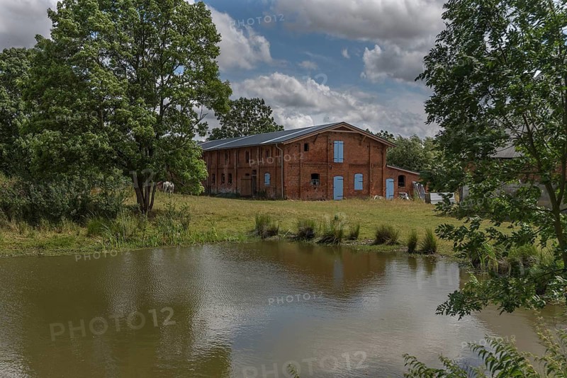 Former pigsty from 1920 on an estate, in front of the extinguishing pond, Othenstorf, Mecklenburg-Vorpommern, Germany