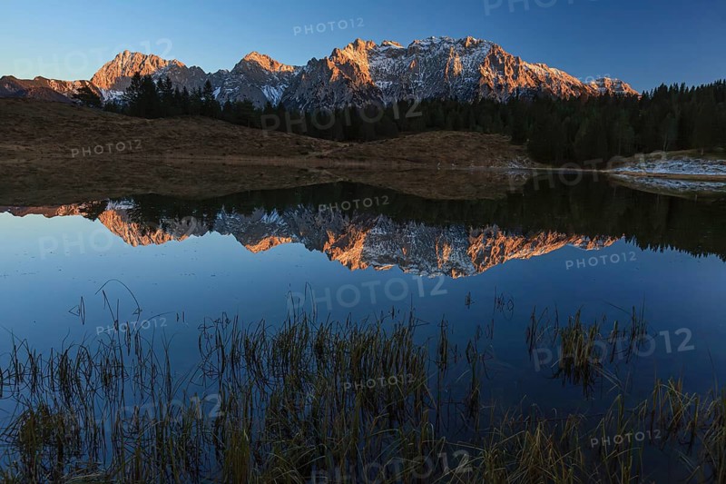 Mountains reflected in lake, evening light, autumn, Wildensee, Karwendel Mountains, Mittenwald, Bavaria, Germany