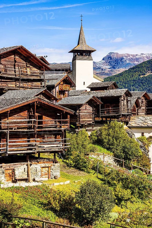 Old wooden houses and the Saint Theodule church in the historic village centre, Grimentz, Val d'Anniviers, Valais Alps, Canton Valais, Switzerland