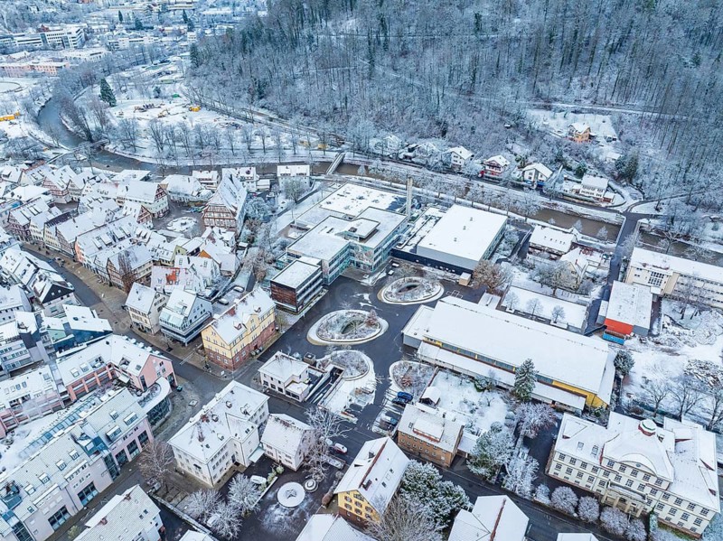 Snow-covered buildings and streets in a neighbourhood, seen from the air, quiet winter atmosphere, Nagold, Black Forest, Germany