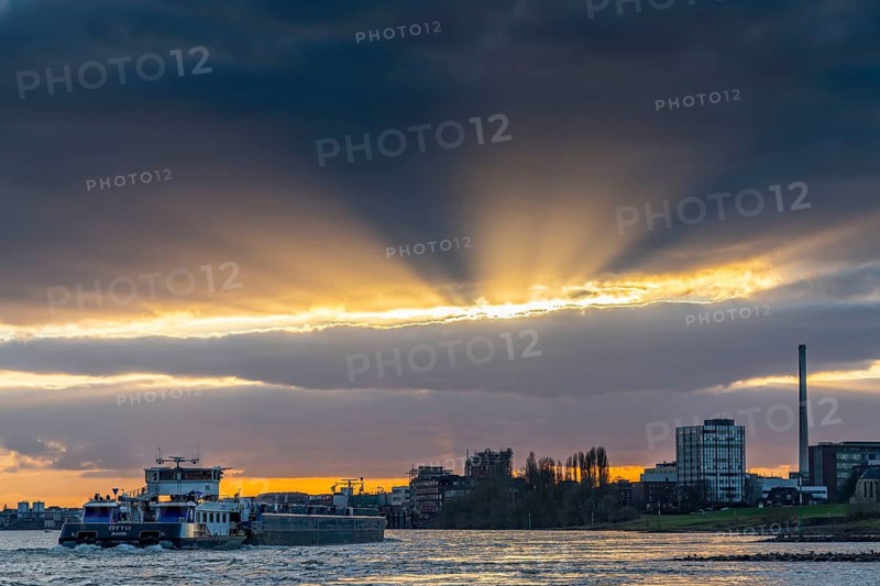 Cargo ship on the Rhine between Duisburg and Krefeld, dramatic sunset, North Rhine-Westphalia, Germany