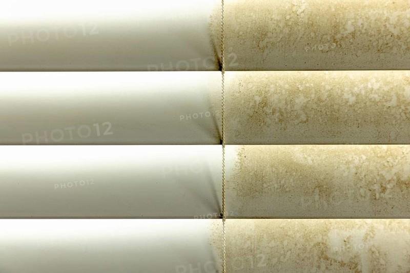 Residential window shades showing the before and after of a good cleaning, one side clean and one side dirty