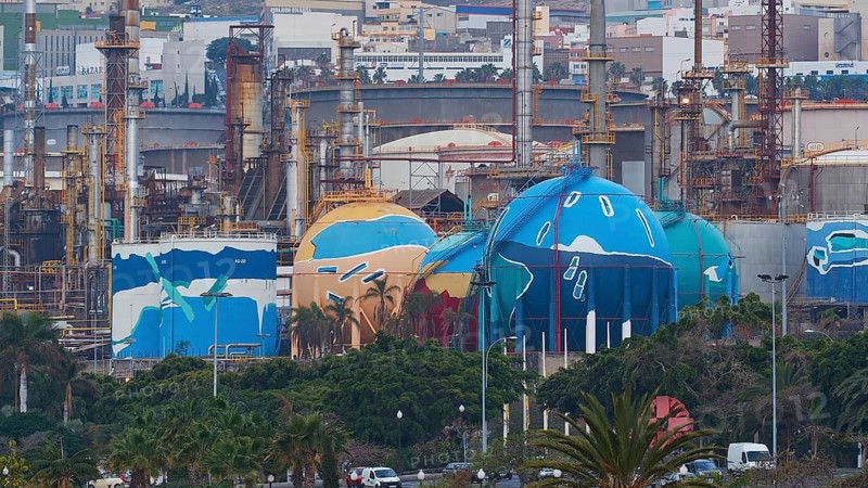 Factory complex with colorful painted tanks and urban background, capital city, Santa Cruz de Tenerife, Santa Cruz, Tenerife, Canary Islands, Spain