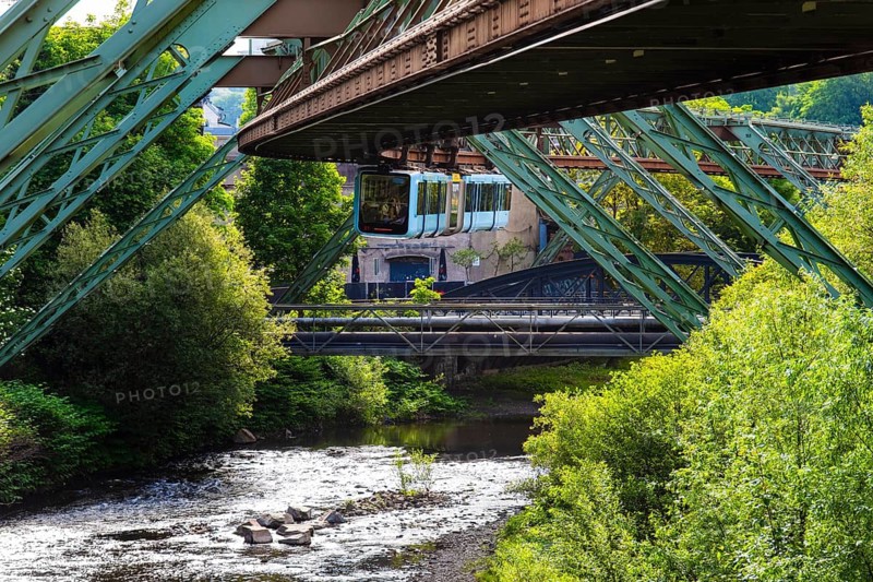 The Wuppertal suspension railway runs through a historic district and industrial area near the Westende stop in Wuppertal, Germany