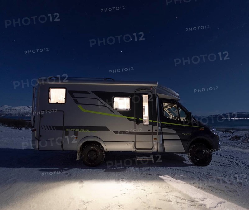 Motorhome in winter at night in front of the constellation of the Big Dipper (Ursa Major), Finnmark, Norway