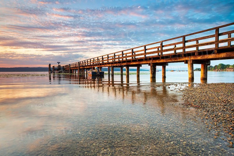 Morning atmosphere at the Lake Ammer, jetty in the first morning light, near Riederau, Bavaria, Germany