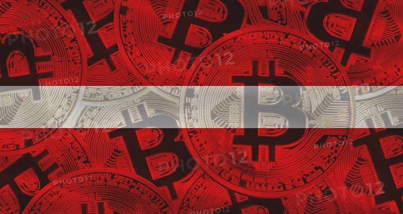 Investors in cryptocurrency and Blockchain Technology in Latvia, Concept.Golden bitcoin coins on Latvian flag background