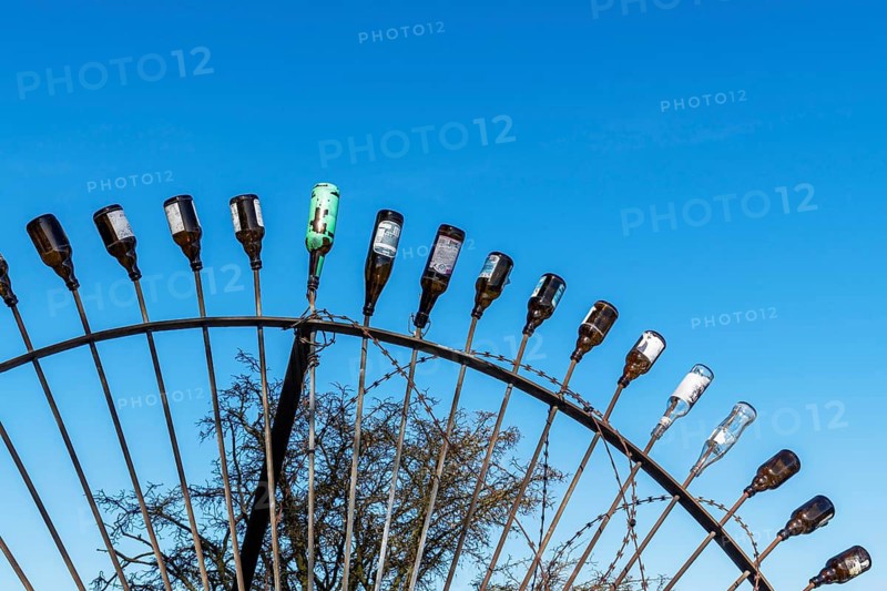 Discarded glass beer bottles on the steel tips of a barrier, Steinwerder, Hamburg, Germany