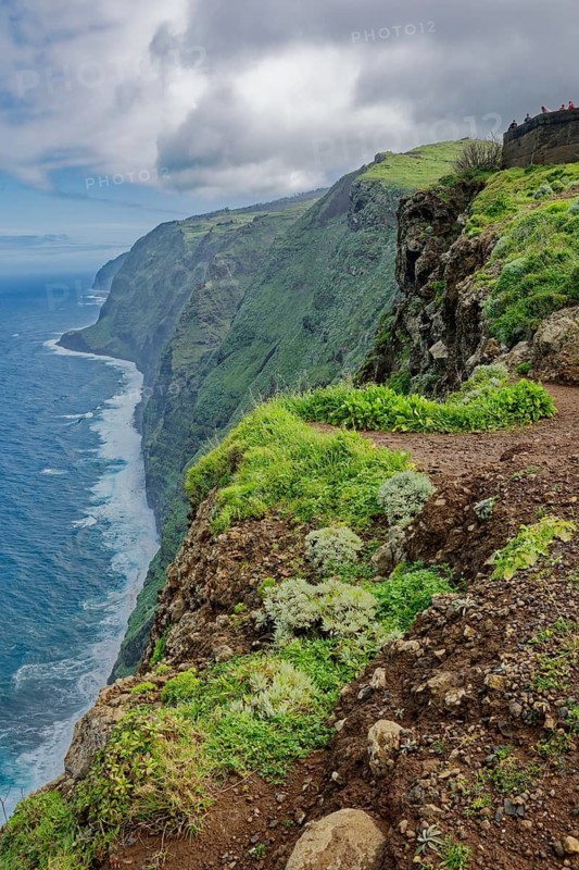 View of the cliffs and the Atlantic Ocean from the Ponta do Pargo lighthouse viewpoint in rainy weather, Ponta do Pargo, Madeira, Portugal