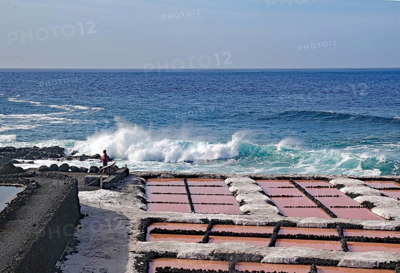 Salt pans at the edge of the sea, with breaking waves in the background under a clear sky, salt flats, Fuencialente, La Palma, Canary Islands, Spain