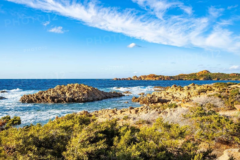 Landscape of the coastline with blue water at Marinedda Coast on a sunny day, Sardinia, Italy