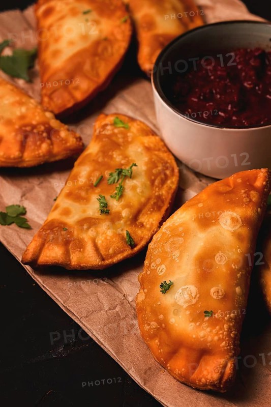 Fried mini pasties, with red sauce, top view, close-up, no people, selective focus