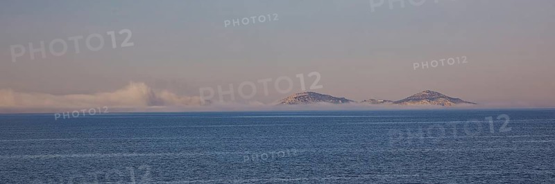 Two islands on the horizon in the morning light with calm sea surface, crossing Rhodes to Symi, ferry, Symi, Dodecanese, Greek Islands, Greece