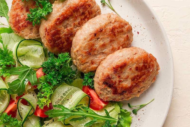 Fried cutlets, turkey, with vegetable salad, top view, no people