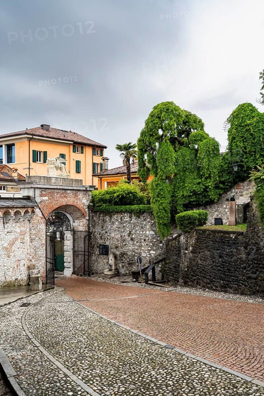 Entrance gate to Castello di Udine Castle, dramatic sky, old town, Udine, Friuli-Venezia Giulia, Italy