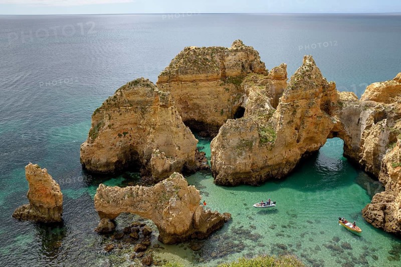 Excursion boats on the rocky coast near Lagos, Algarve, Portugal