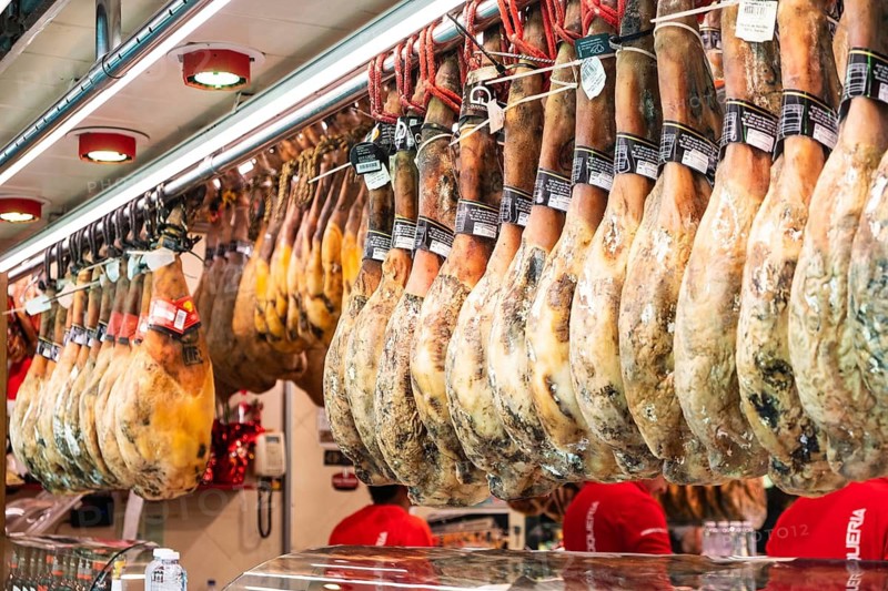 Ham at a market stall at La Boqueria market in Barcelona, Spain