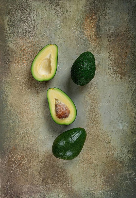 Fresh sliced avocado on the table, top view, food background, concept, menu, food styling