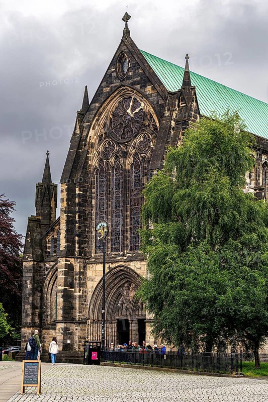 Medieval Gothic facade of Glasgow Cathedral shows transept facade with rose window and and a copper roof, Glasgow, Scotland, United Kingdom