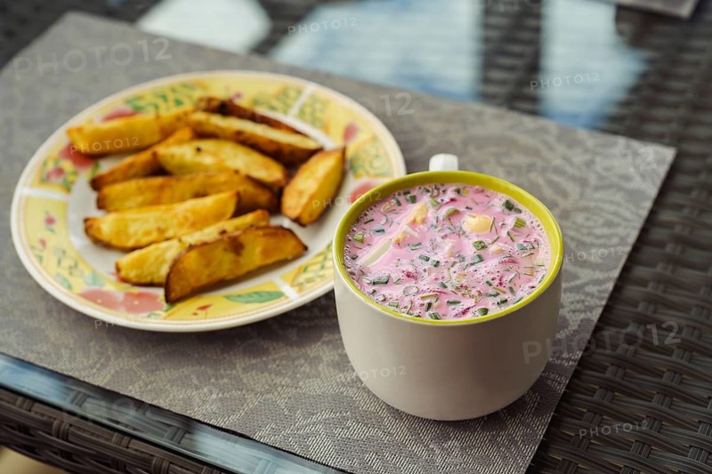 Cold Lithuanian soup Saltibarsciai, a cold summer soup made of beetroot and kefir, popular in Lithuania, Latvia, Poland and Belarus, served with baked potatoes