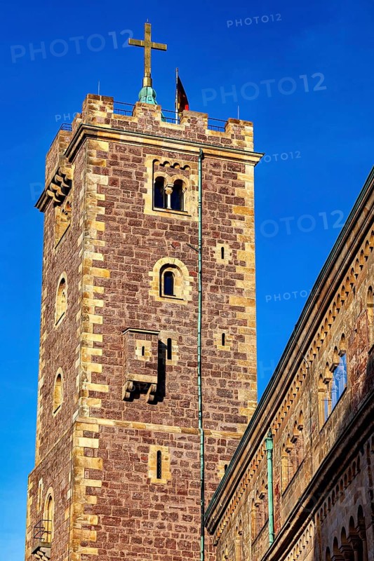 Close-up of a tower with a cross on the roof, surrounded by a historic stone building, The Wartburg near Eisenach in Thuringia