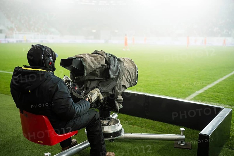 Cameraman next to the playing field during soccer match in Lubin, Poland