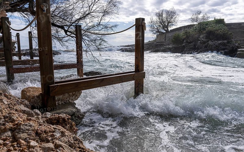 Wooden walkway destroyed by the sea, east coast in Cala Ratjada, Majorca, Spain