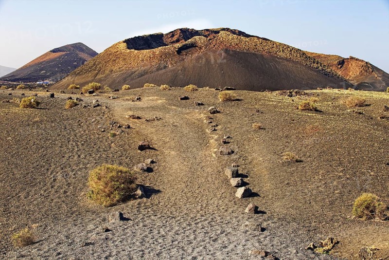 A barren volcanic landscape with dry ground in a lonely atmosphere, El Cuervo Volcano, Lanzarote, Canary Islands, Spain