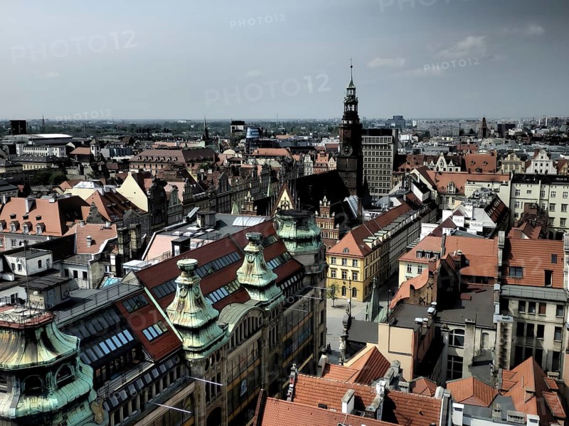 A panorama, view from the tower of St. Elisabeth Church over the old town of Wroclaw, a city with red roofs and a central tower in clear skies, Wroclaw, Poland