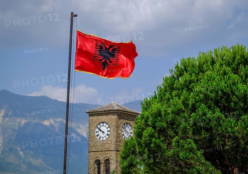 City of Gjirokastra, Gjirokastra, Albania, Albanian flag flies on the castle of the mountain town of Gjirokastra, UNESCO World Heritage Site