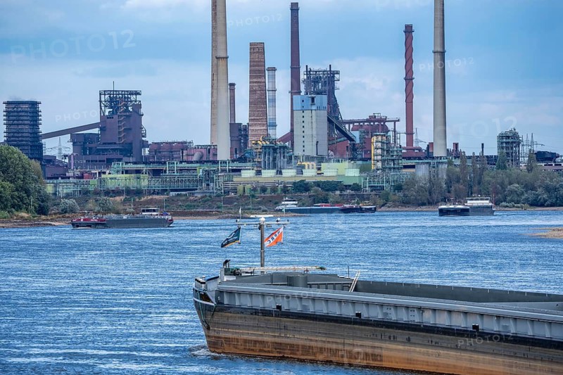 Barges, freighters, on the Rhine near Duisburg, in the back the ThyssenKrupp Steel Mill, after the historic low tide, shipping traffic came to an almost complete standstill, now the cargo ships are sailing again after it had rained for 2 days and the level in the Rhine rose by more than 25 cm, but still with reduced cargo, North Rhine-Westphalia, Germany