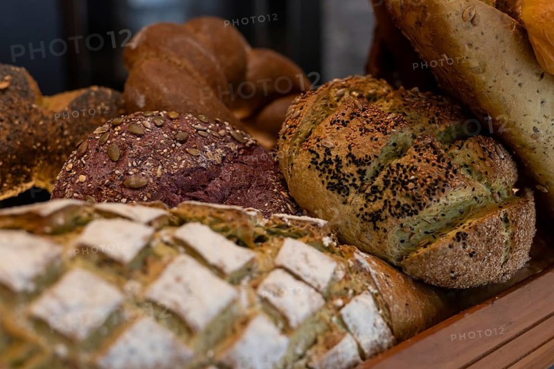A variety of artisanal breads showcased in a basket. The display features different textures and colors, highlighting the craftsmanship of local baking. Homemade fresh bread