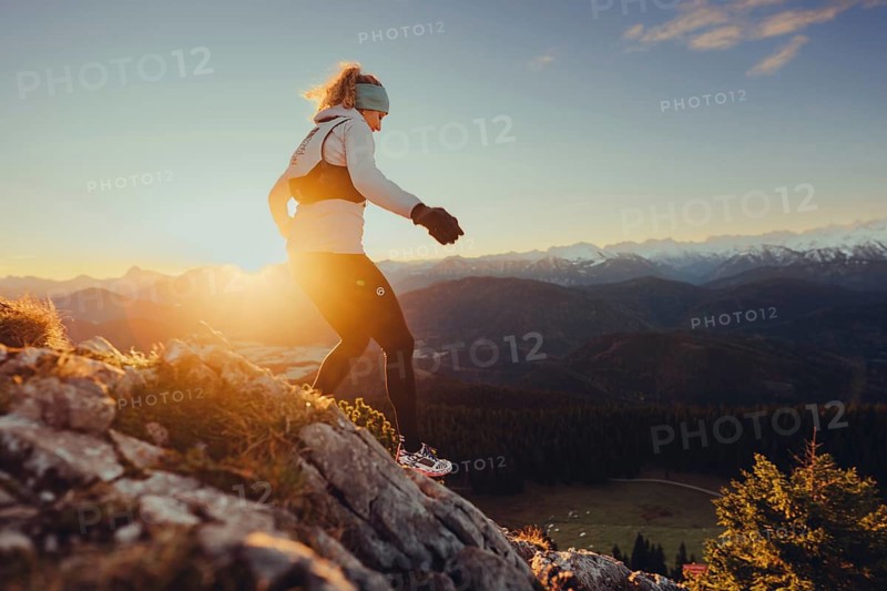 Trail running in autumn on the Jochberg on Lake Walchensee against the wonderful backdrop of the Alps, Bavaria, Germany