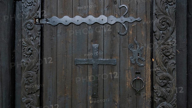 Decorated wooden door with a large metal cross and wrought-iron fittings, backdrop Kristin Lavranstochter film, Jørundgard Middelaldersenter, Olavsweg or Olavsleden, Sel municipality, Gudbrandsdalen, Norway