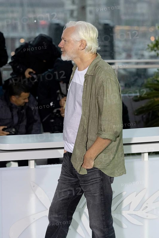 Cannes, France - 20.5.2024: Julian Assange wears a T-shirt under his shirt with names of people killed in Gaza on the front and - Stop Israel - on the back during - The Six Billion Dollar Man - photocall during the 78th Cannes International Film Festival. The film festival takes place from 13 to 24 May 2025