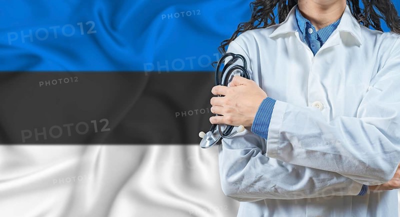 Healthcare professional with Estonia flag background. Professional doctor holding stethoscope on Estonia flag background