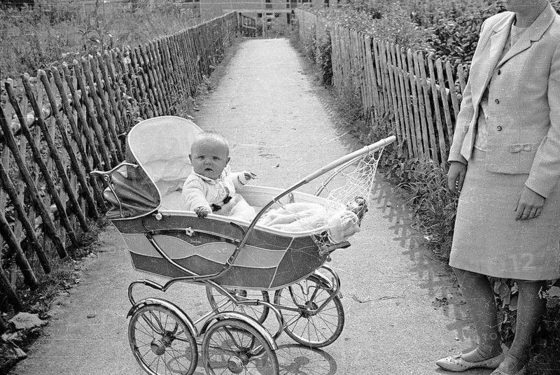 Baby lying in stroller, mother standing next to it, Arnsberg, Sauerland, North Rhine-Westphalia, Germany, summer 1962, retro, vintage, old, historic