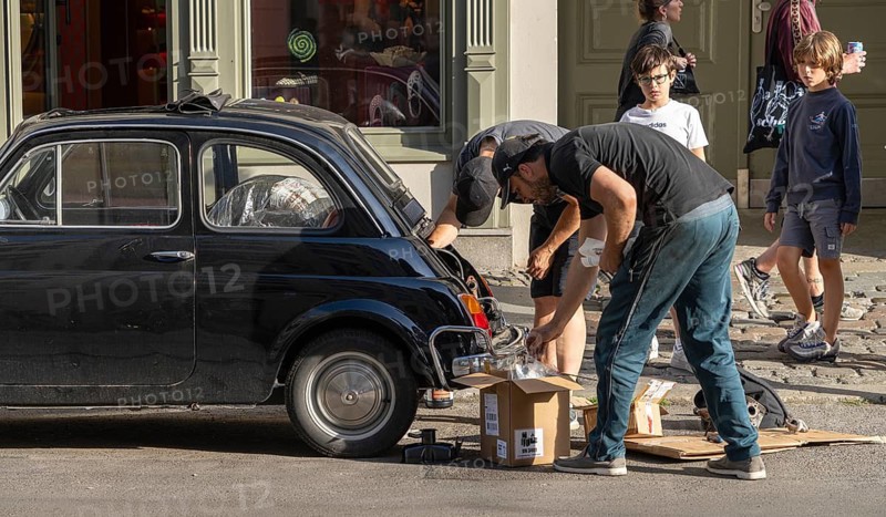 Two men repair the engine of a Fiat 500, Neue Schönholzer Strasse, Berlin, Germany