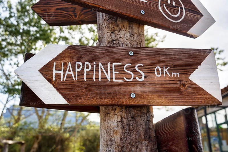 Funny wooden sign with the words Glück 0 km, signpost, symbolic picture destination, direction, distance, arrival, Aragon, Spain
