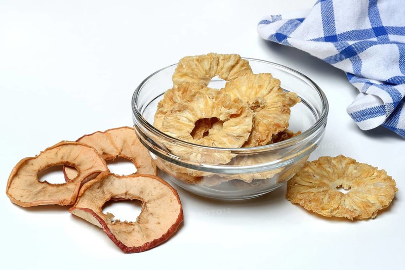 Dried pineapple slices in peel and dried apple rings, dried fruit