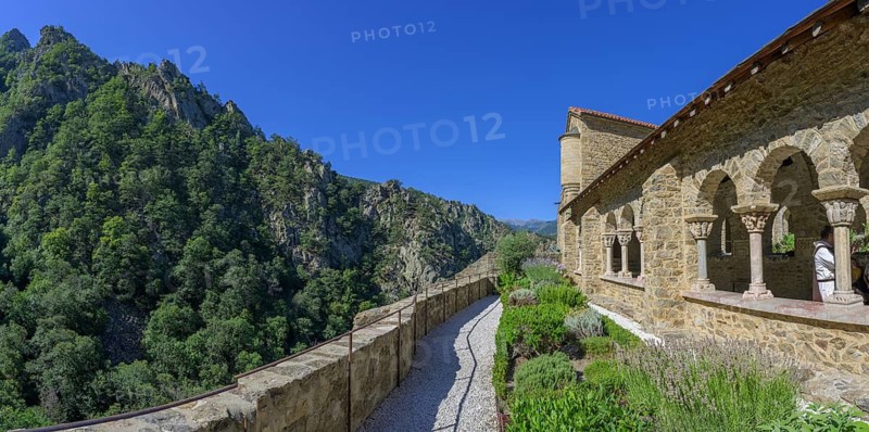 Exterior view of the cloister with small garden at Saint Martin du Canigou Abbey, Casteil, Département Pyrénées-Oriental, France