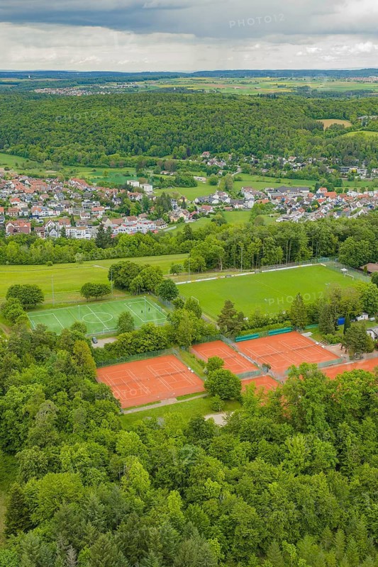 Tennis and soccer fields in the midst of a rural, wooded village landscape, Aidlingen sports field, Böblingen district, Germany