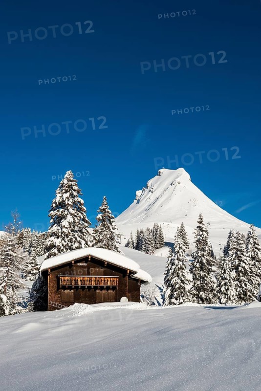 Snow-covered mountains and mountain hut with ski slope, Damülser Mittagspitze, Damüls, Bregenzerwald, Vorarlberg, Austria