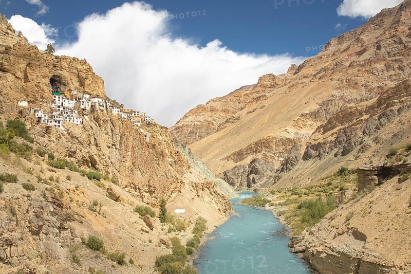 Phugtal Monastery, nestled in the cliffs of the remote Lungnak Valley in Ladakh, offers breathtaking views of the rugged Himalayan landscape and the serene blue river below