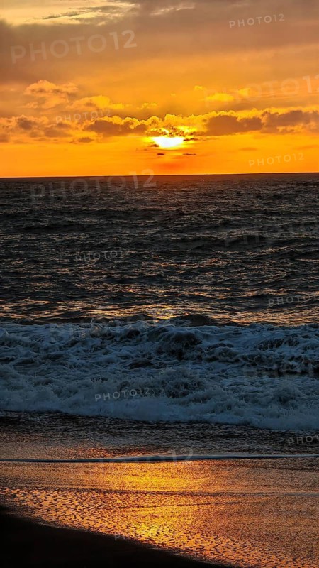 A dramatic sunset over the ocean bathes the sky in warm shades of orange and gold, hiking, Tarrafal de Monte Trigo, Santo Antao, Cabo Verde, Cape Verde, Cape Verde